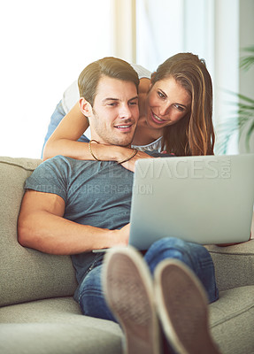 Buy stock photo Couple, laptop and hug on home sofa while on internet for remote work or streaming movies. A man and woman together in a house while happy about online shopping, search or internet connection