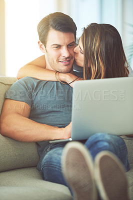 Buy stock photo Kiss, computer and woman hugging man on sofa networking on social media, website or internet. Happy, love and female person embracing husband reading online blog with laptop in living room at home.