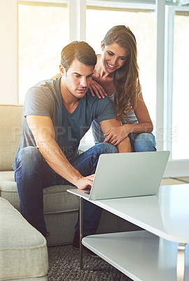 Buy stock photo Couple, home and couch with laptop, bonding and entertainment in living room with smile and laugh. Man, woman and sofa with embrace, relax and love while pointing at tech in lounge at house 