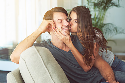 Buy stock photo Woman, kiss and man on cheek for couple relax at home in love, intimacy and happy spending time together. Happiness, commitment or trust in relationship with people in living room, affection and care