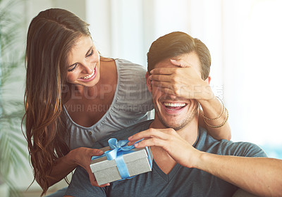 Buy stock photo A young woman covering her husband's eyes for a surprise gift