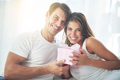 Buy stock photo Portrait, gift and valentines day with a couple in bed together at home for a romantic celebration. Love, box or present with a man and woman in the bedroom of a house for a birthday or anniversary