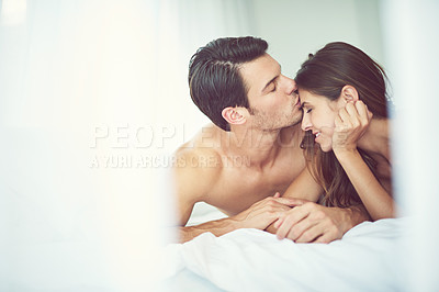 Buy stock photo Romantic, love and man kissing his wife in the morning after an anniversary, date or intimate time in bed. Gratitude, relax and young couple in the bedroom showing care and bonding for valentines day