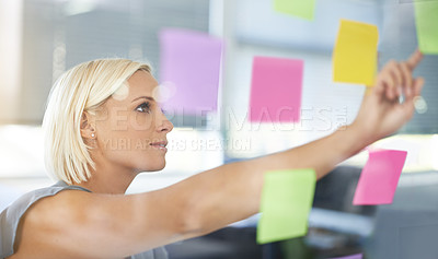 Buy stock photo Woman, glass and board with pointing, thinking and notes for planning, proposal and idea development. Person, wall and paper for brainstorming process, decision or choice with smile in modern office