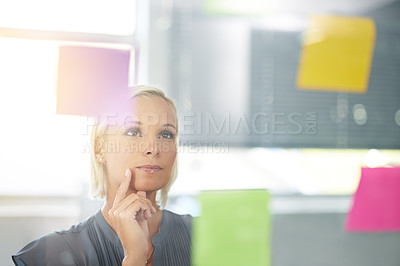 Buy stock photo Woman, glass and board with thinking, planning and notes with reading, proposal and ideas for development. Person, wall and paper with brainstorming process, decision and choice with modern office