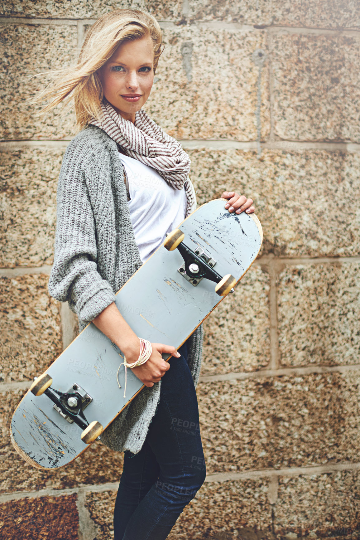 Buy stock photo Woman, skateboard and portrait in city for travel, fashion and brick wall in urban area. Female person, casual and street style in New York for commute, sidewalk and stylish with pride outside.