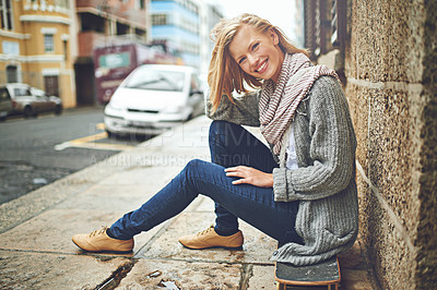 Buy stock photo Full length portrait of an attractive young woman sitting on her skateboard in the city