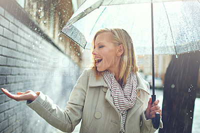 Buy stock photo Smile, happy woman and rain feeling water in the city with umbrella, freedom and happiness. Winter weather, raining and urban street with a young female person on a sidewalk and vacation outdoor