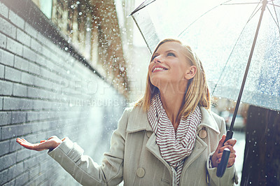 Buy stock photo Smile, woman and raindrops in the city with umbrella, freedom and happiness on holiday. Winter weather, raining and urban street with a young female person on a sidewalk and vacation outdoor