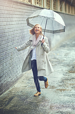 Buy stock photo Full length shot of an attractive young woman playing in the rain