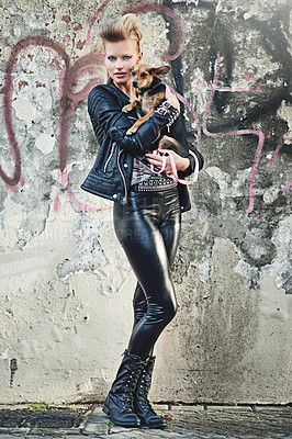 Buy stock photo Dog, portrait and woman in leather clothes by graffiti wall, confident and bonding with chihuahua in city. London, designer or face for fashion in town, vacation or care for pet animal by street art
