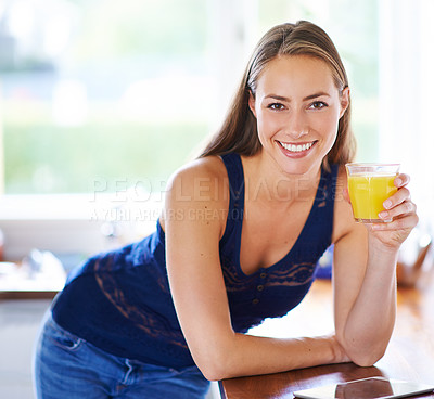 Buy stock photo Shot of a young woman having a glass of orange juice at home