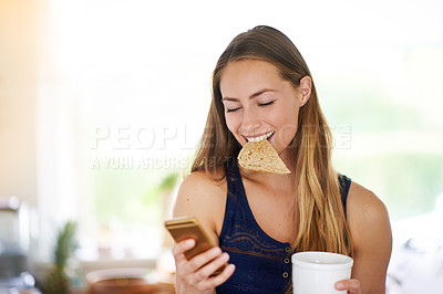Buy stock photo Shot of a woman using her cellphone,eating toast and having coffee
