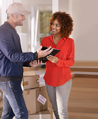 Buy stock photo Shot of a courier making a delivery to a smiling customer