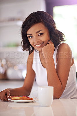 Buy stock photo Portrait of a young woman enjoying breakfast at home