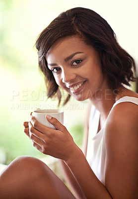 Buy stock photo Shot of a young woman drinking a beverage at home