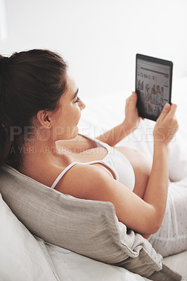 Buy stock photo Pregnancy, woman and screen of tablet on bed for social media, maternity research and planning. Mother, relax and idea with digital technology for website, motherhood blog and information at home