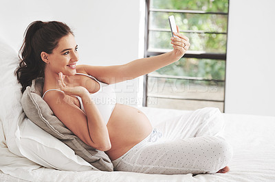 Buy stock photo Pregnant, selfie and woman with smile for video call, picture and vlog or live streaming at home on bed to relax. Mother, stomach or influencer for pregnancy by window in bedroom for maternity leave