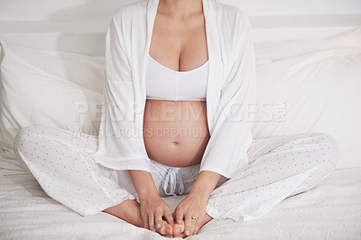 Buy stock photo Cropped shot of a pregnant woman at home