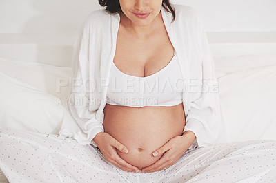 Buy stock photo Woman, pregnant and holding belly at home for healthy maternity, growing family or developmental support. Person, smiling and excited for motherhood, love or bonding and caring for unborn baby