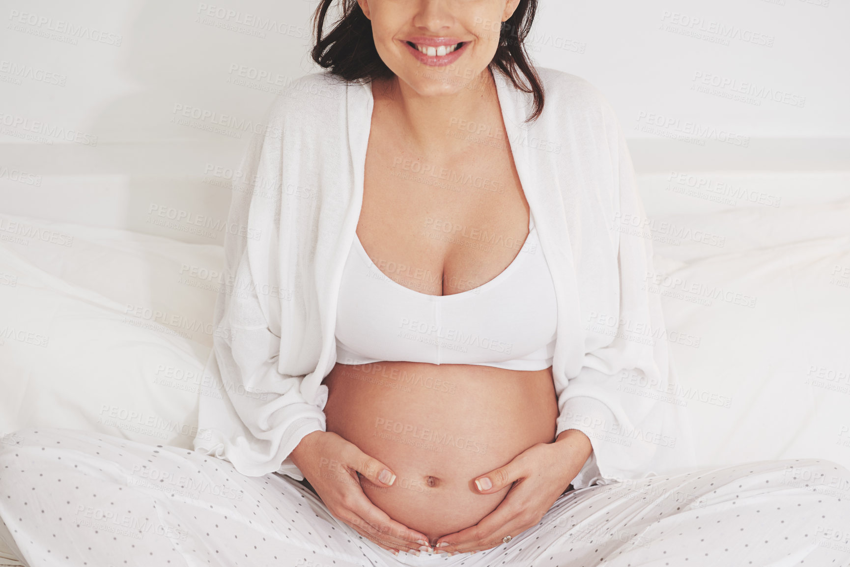 Buy stock photo Woman, home and pregnant with smile in bed for child, expecting and satisfied in bedroom. Female person, maternity and touching stomach in sleepwear with happiness, pride and joy as mother with care