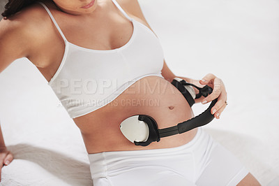 Buy stock photo Pregnant, stomach and listening to music with headphones so baby relax to sound in womb for brain development. Pregnancy, belly and streaming audio to calm fetus with lullaby in home with mother