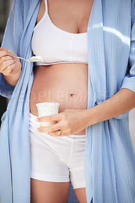 Buy stock photo Pregnancy, belly and woman in home with yogurt for snack, craving and nutrition in bedroom. Pregnant person, abdomen and dessert or ice cream for vitamin, protein and wellness for tummy or stomach