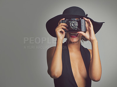Buy stock photo Fashion, camera and elegant woman in hat, studio and smile isolated on gray background. Face, confident and style for summer outfit, classy aesthetic and clothes with glamour cosmetics in Brazil