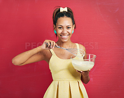 Buy stock photo Woman, portrait and baking or housewife in studio or mixing in dress for dessert snack, cooking or whisk. Female person, face and red background with mockup space for sweets candy, happy or mock up