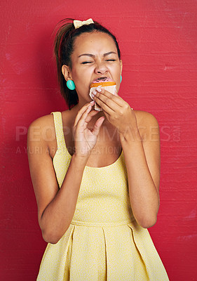Buy stock photo Cake, eating and woman with cupcake on red background birthday, event or special, snack and guilty pleasure. Sugar, dessert and hungry female person with sweet food addiction, craving or diet fail