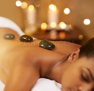 Buy stock photo Cropped shot of a young woman enjoying some lastone therapy at the spa