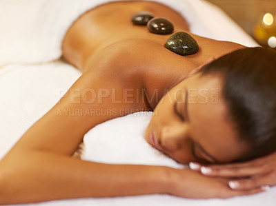 Buy stock photo Spa, stone and woman with massage, vacation and relaxing with stress relief, skincare and body luxury. Person, peaceful and girl with health, treatment and calm with zen therapy masseuse and holiday