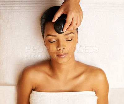 Buy stock photo Woman, relax and spa with hot rock for facial treatment, zen or stress relief above at resort. Top view of calm female person with stone on face for beauty, wellness or therapy in relaxation at salon