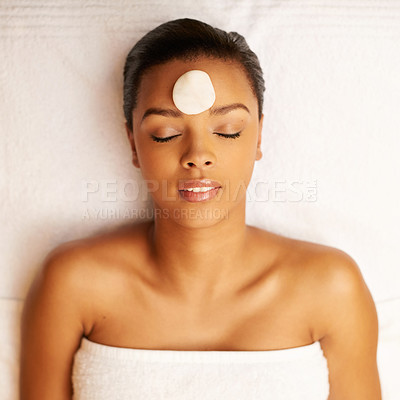 Buy stock photo Woman, sleeping and spa with hot rock above for facial treatment, zen or stress relief at luxury resort. Top view of calm female person with stone on face for beauty in relaxation on massage bed