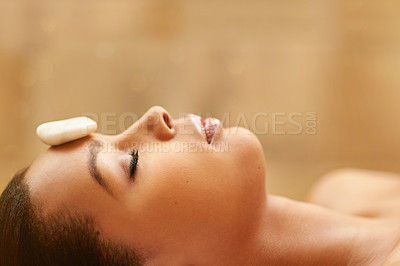 Buy stock photo Woman, sleeping and spa with rock for facial treatment, zen or stress relief at luxury resort. Profile of calm female person with stone on face for beauty, wellness or therapy in relaxation at salon