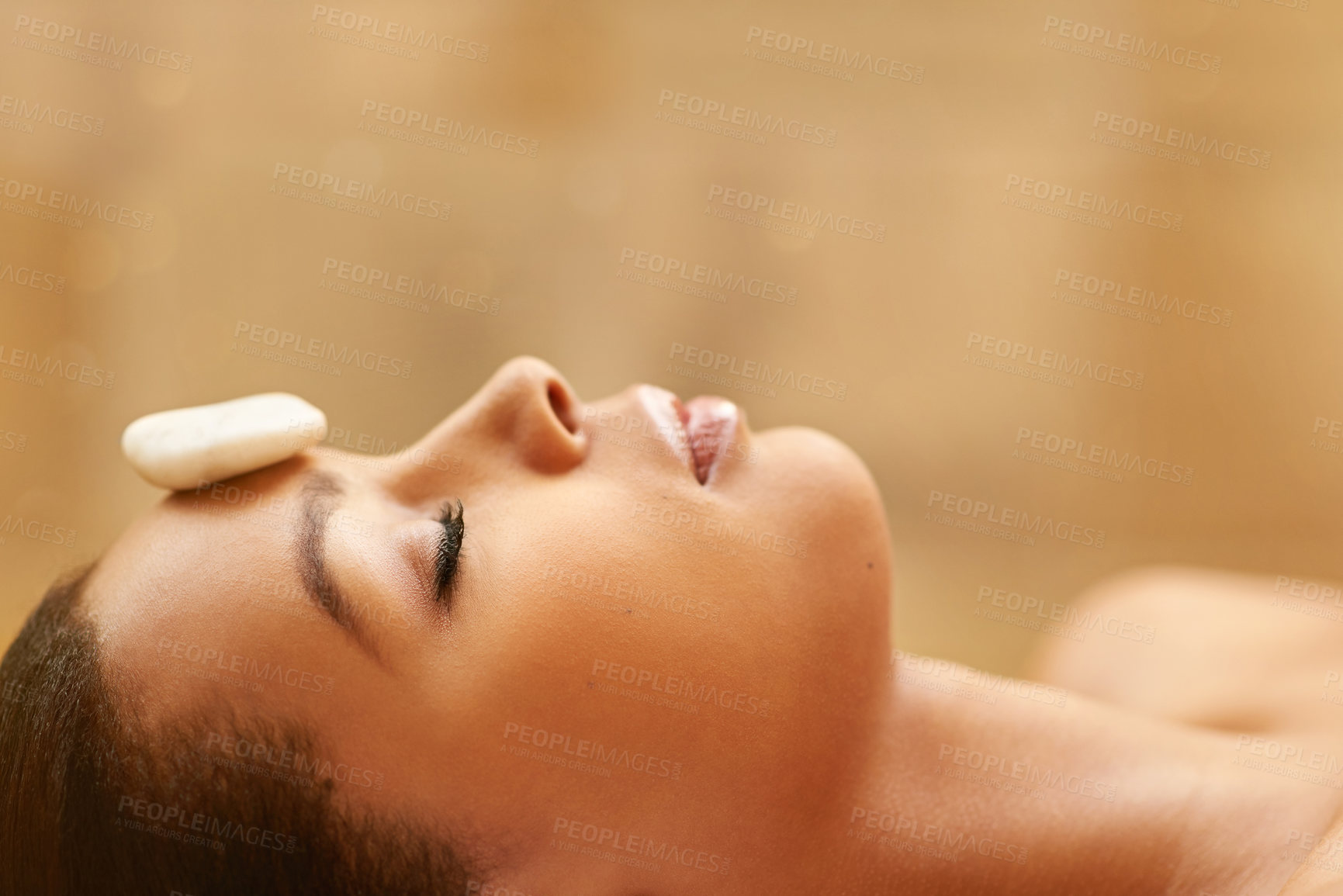 Buy stock photo Woman, sleeping and spa with rock for facial treatment, zen or stress relief at luxury resort. Profile of calm female person with stone on face for beauty, wellness or therapy in relaxation at salon