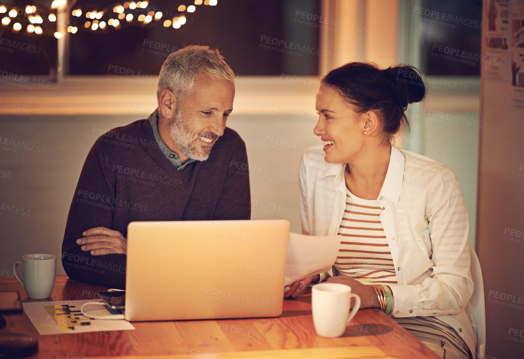 Buy stock photo Business people, meeting and planning late at night in office for teamwork, collaboration and communication. Mature man, woman and smile with computer for discussion, brainstorming and budget plan