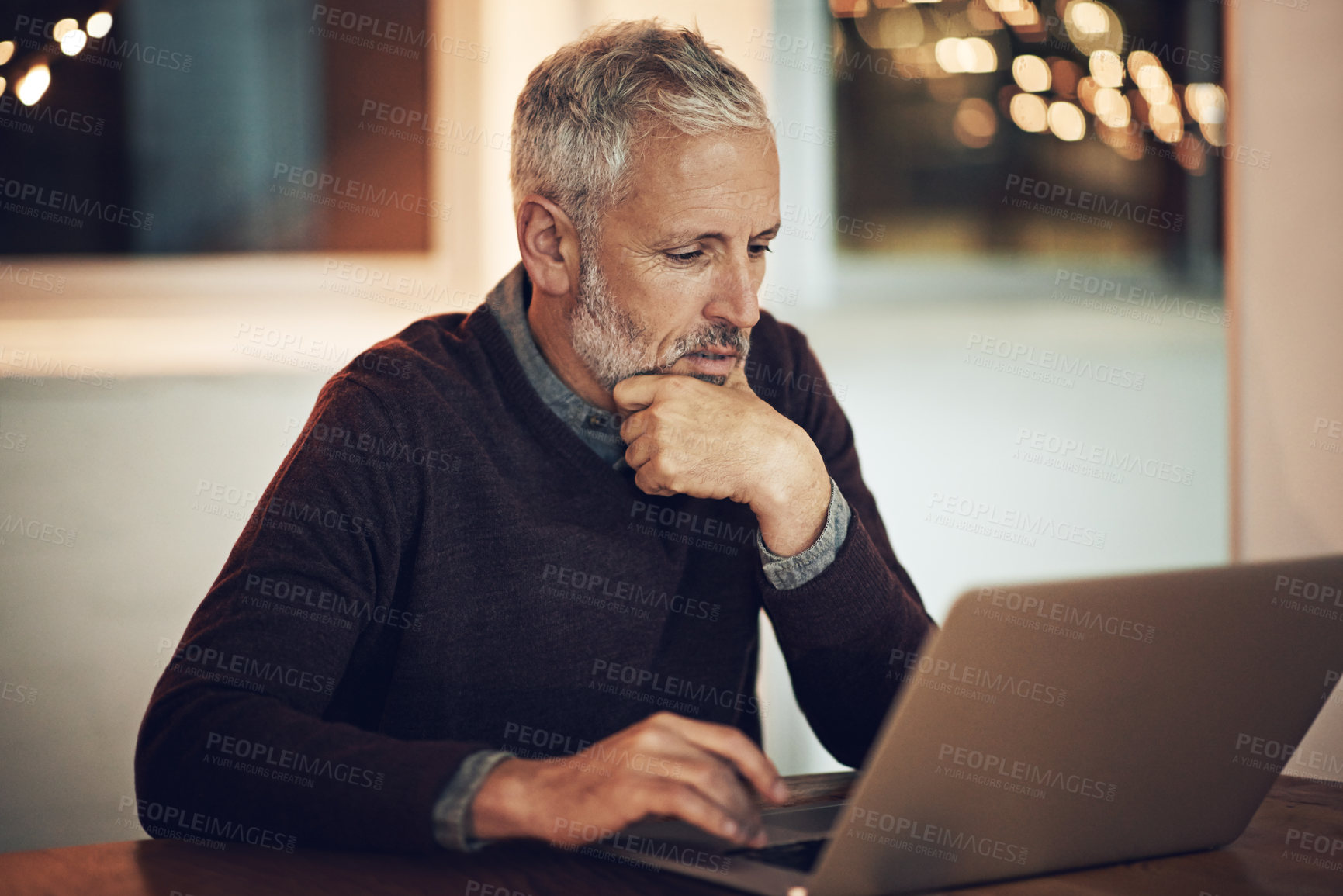 Buy stock photo Cropped shot of a mature businessman working late at the office