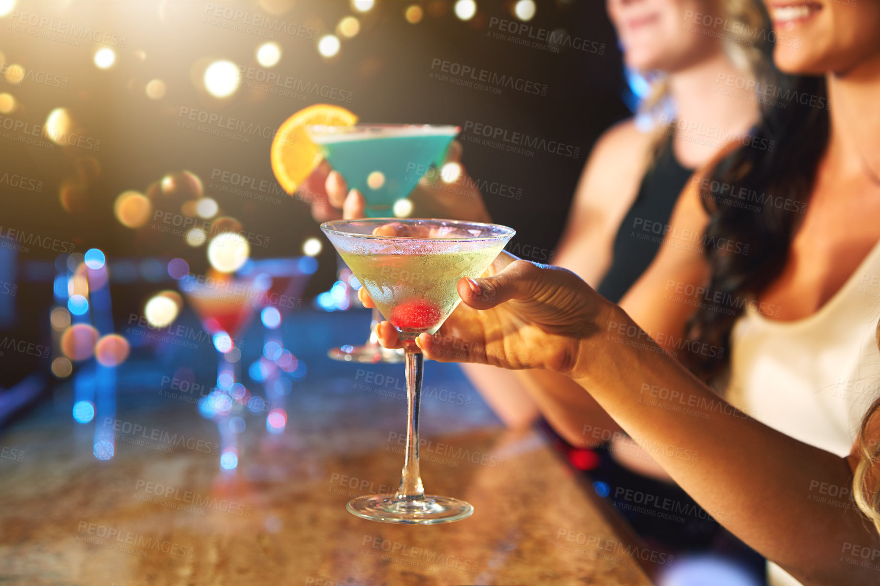 Buy stock photo Cropped shot of women drinking cocktails in a nightclub