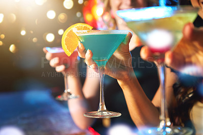 Buy stock photo Cropped shot of women drinking cocktails in a nightclub