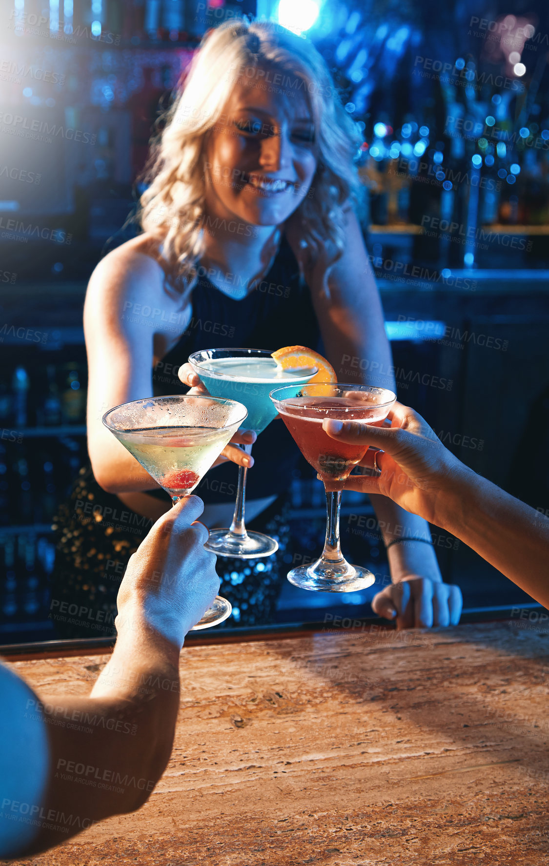 Buy stock photo Shot of young women drinking cocktails in a nightclub