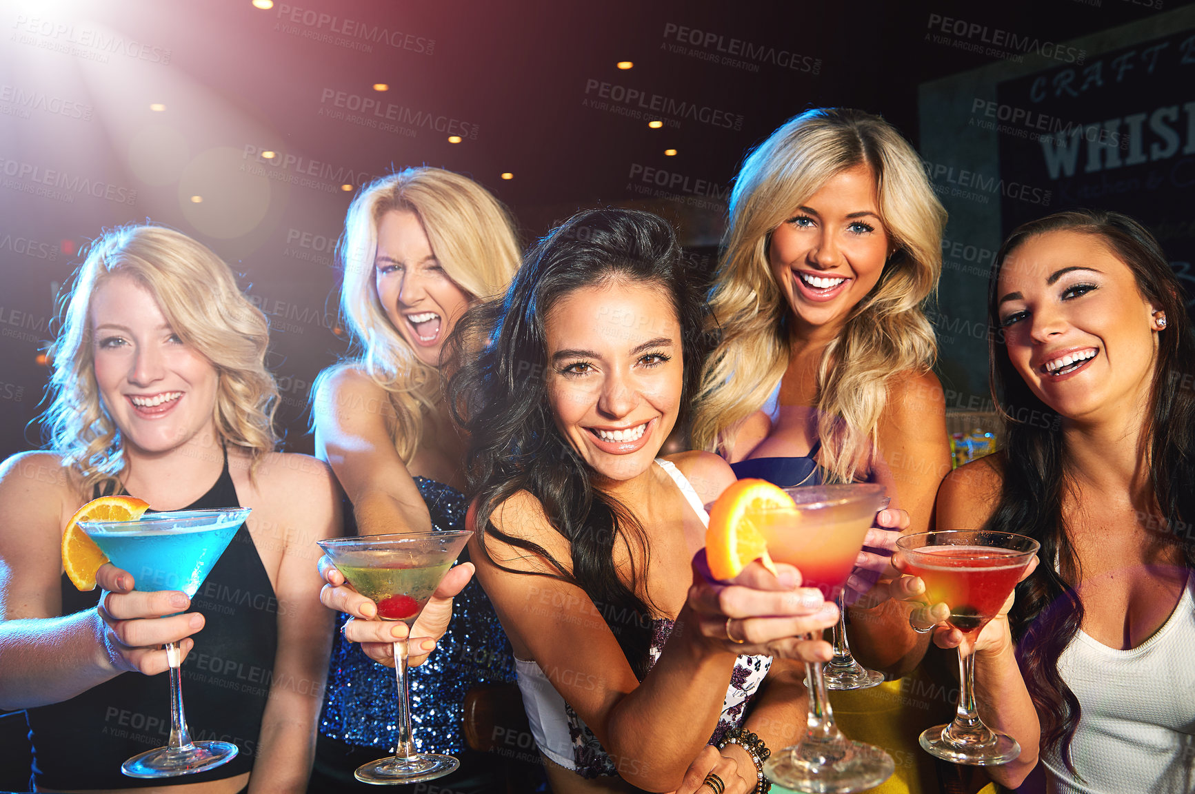 Buy stock photo Shot of young women drinking cocktails in a nightclub