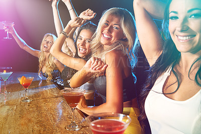 Buy stock photo Shot of young women partying in a nightclub