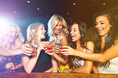 Buy stock photo Shot of young women drinking cocktails in a nightclub