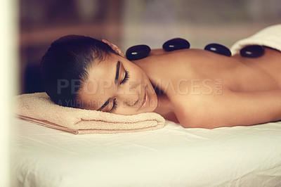 Buy stock photo Girl, rocks or back massage in spa to relax for zen resting, sleeping or wellness physical therapy hotel resort. Calm woman in salon to exfoliate for body healing treatment or hot stone detox therapy