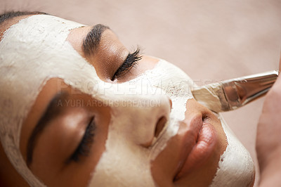 Buy stock photo Cropped shot of a young woman receiving a facial treatment at a spa