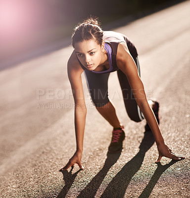 Buy stock photo Shot of a young woman in the starting position for a run