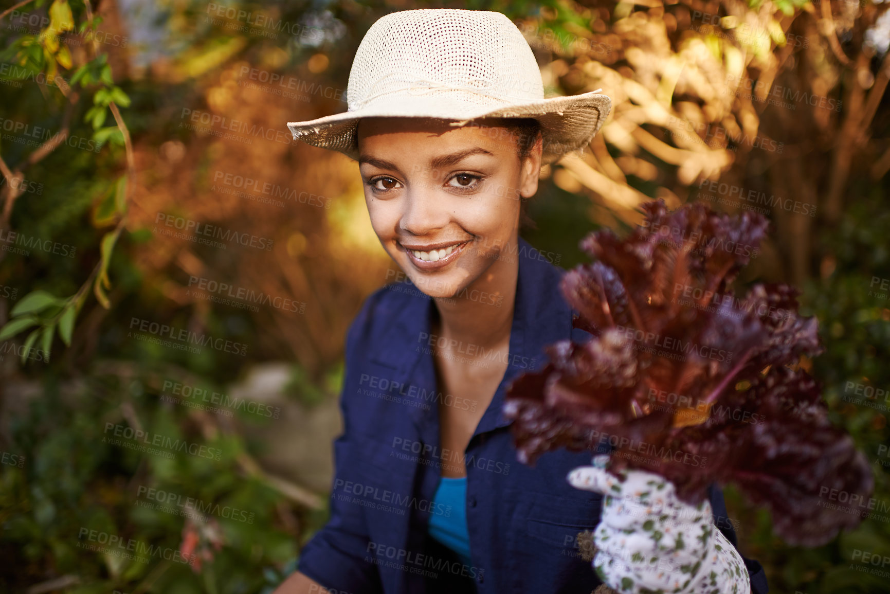 Buy stock photo Shot of a young woman gardening in her backyard