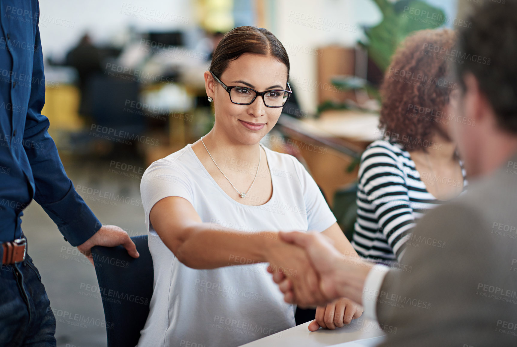 Buy stock photo Happy, female person and meeting with handshake in office for creative startup, teamwork and feedback for staff. Man, partner and greeting employee in professional workplace for review with report 