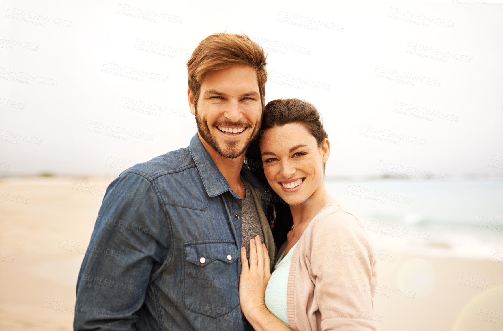 Buy stock photo Couple, portrait and embrace at beach for travel, romance and freedom together outdoors. Face, smile and happy woman hugging man on trip, vacation or holiday, bond or having fun standing in Bali